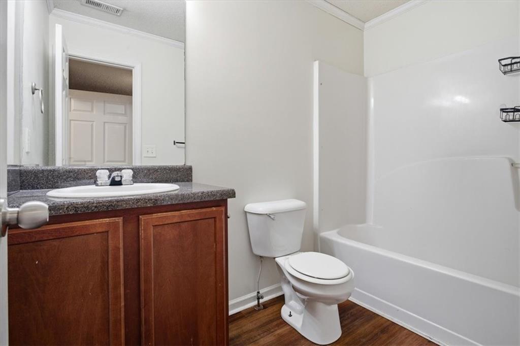 3018 Broadleaf Trail Road Fairburn, GA 30213 - Photo 12 of 26 a bathroom with a granite countertop toilet a sink and a mirror