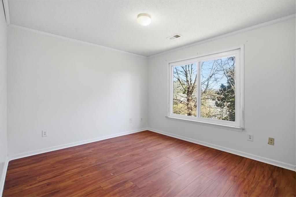 3018 Broadleaf Trail Road Fairburn, GA 30213 - Photo 16 of 26 an empty room with wooden floor and window