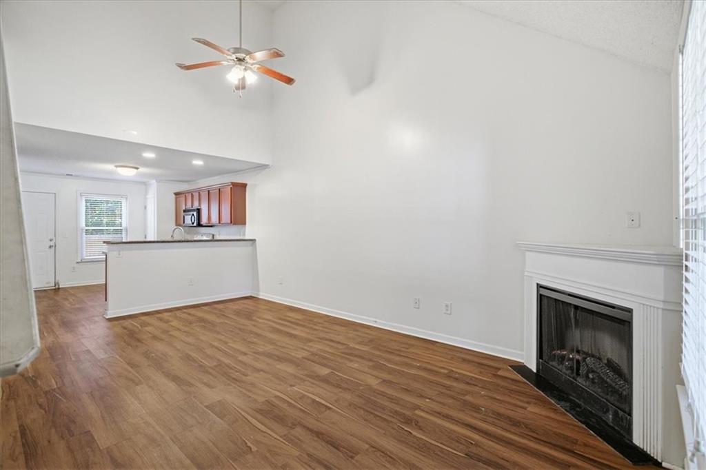 3018 Broadleaf Trail Road Fairburn, GA 30213 - Photo 5 of 26 a view of empty room with wooden floor and fireplace