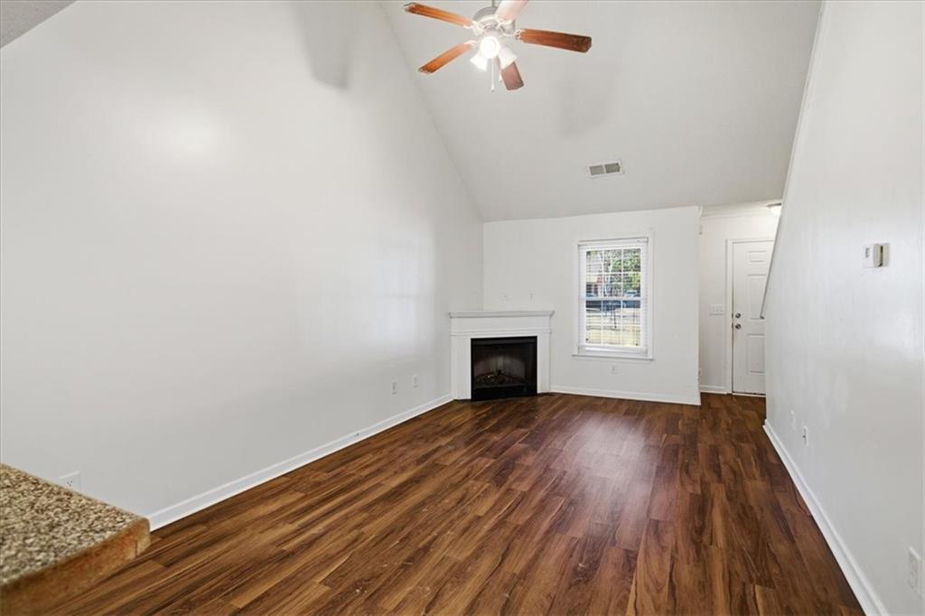 3018 Broadleaf Trail Road Fairburn, GA 30213 - Photo 6 of 26 a view of an empty room with wooden floor and a window