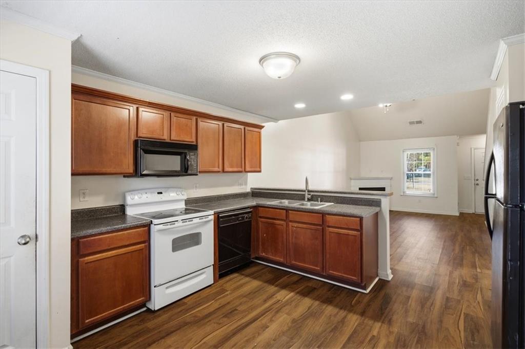 3018 Broadleaf Trail Road Fairburn, GA 30213 - Photo 7 of 26 a kitchen with stainless steel appliances granite countertop a stove top oven and sink