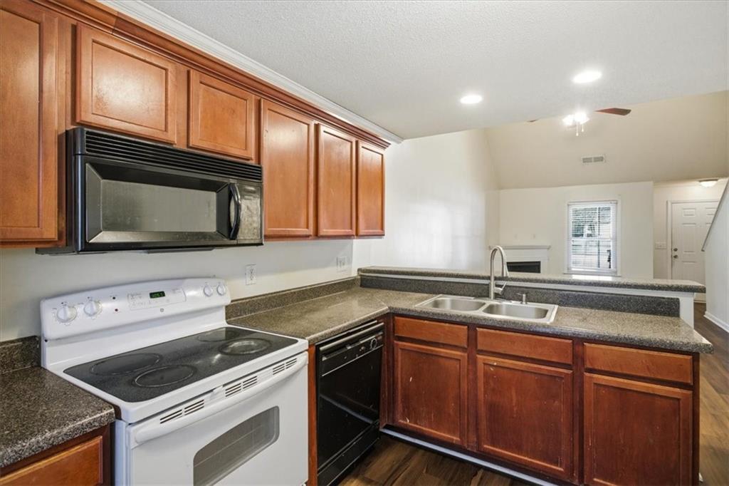 3018 Broadleaf Trail Road Fairburn, GA 30213 - Photo 8 of 26 a kitchen with granite countertop cabinets stainless steel appliances and a sink