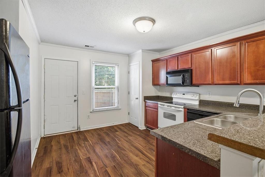 3018 Broadleaf Trail Road Fairburn, GA 30213 - Photo 9 of 26 a kitchen with a sink stove top oven and refrigerator