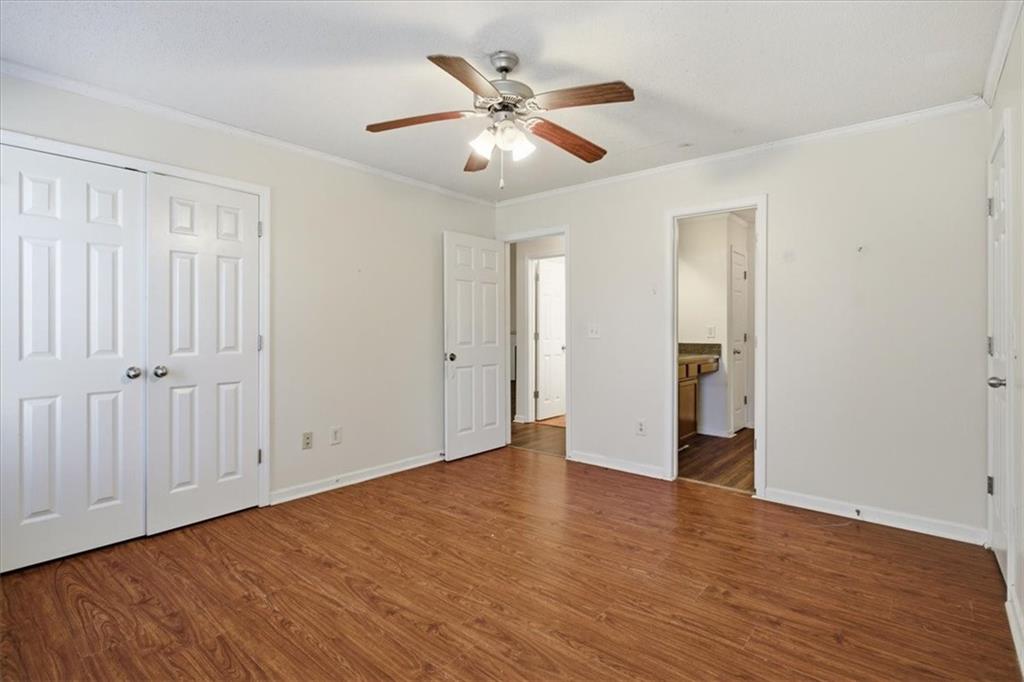 3018 Broadleaf Trail Road Fairburn, GA 30213 - Photo 10 of 26 an empty room with wooden floor and ceiling fan
