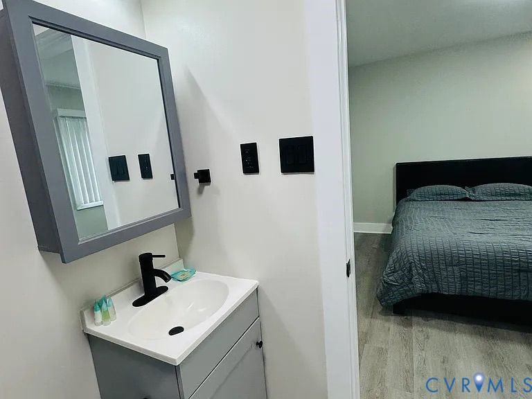 350 Staten Street Norfolk, VA 23503 - Photo 7 of 12 a bedroom with a bed and a mirror
