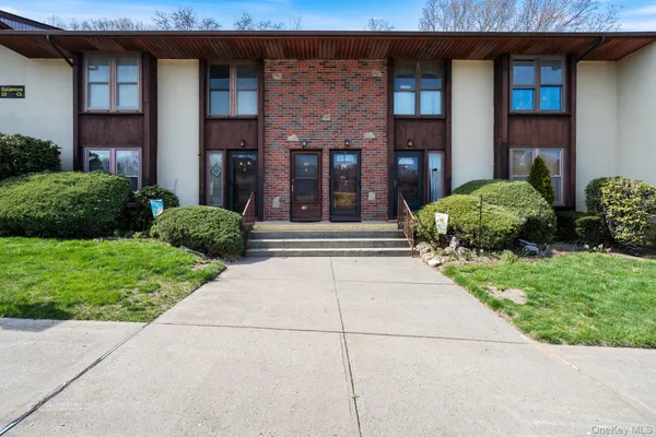 a front view of a brick house with a yard