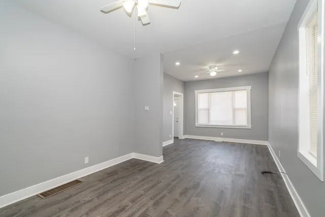 wooden floor in an empty room with a window