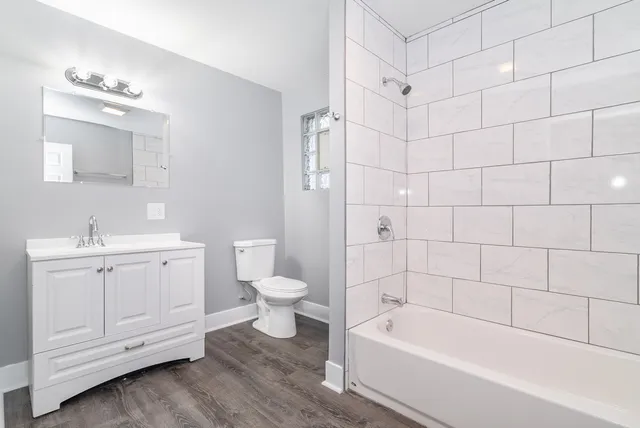 a bathroom with a bathtub a sink a toilet and shower