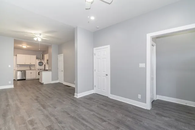 a view of a kitchen with a sink and a refrigerator