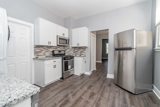 a kitchen with a refrigerator stove and sink