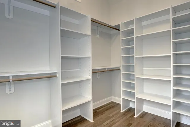 a view of walk in closet with empty racks