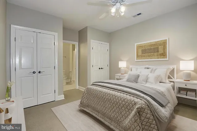 a spacious bedroom with a bed and a chandelier