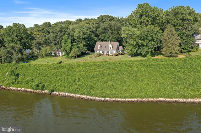 a view of a lake with a yard and mountain in the back