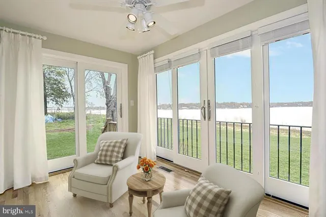 a living room with furniture and a floor to ceiling window