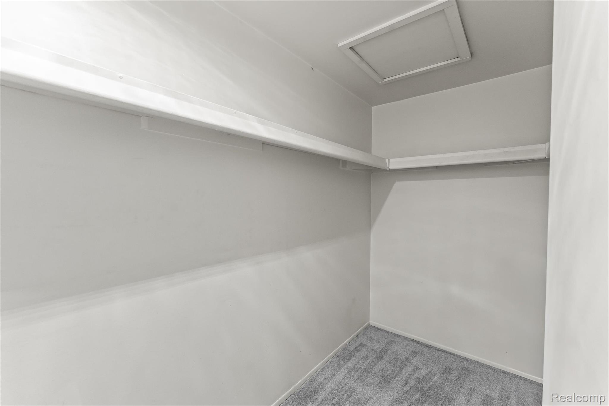 2118 Rutgers Drive Troy, MI 48085 - Photo 23 of 39 Interior closet space featuring light grey walls, grey patterned carpeting, and white shelving