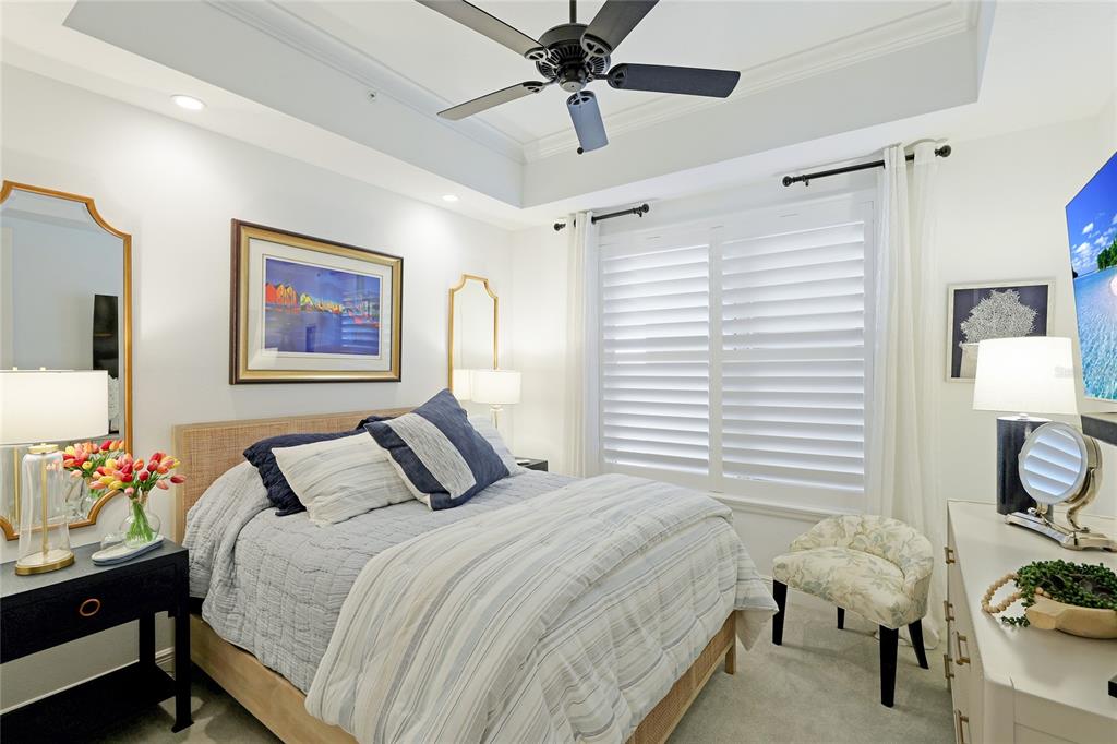 10520 Boardwalk Loop, Unit 704 Lakewood Ranch, FL 34202 - Photo 24 of 55 a bedroom with a bed and a chandelier