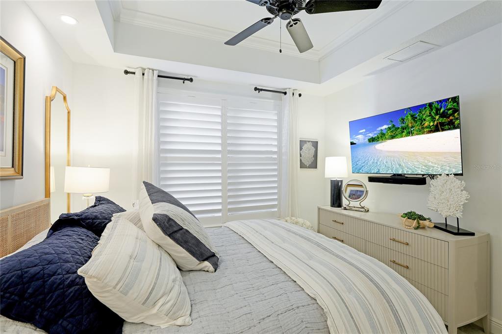 10520 Boardwalk Loop, Unit 704 Lakewood Ranch, FL 34202 - Photo 25 of 55 a bedroom with a bed and a flat screen tv