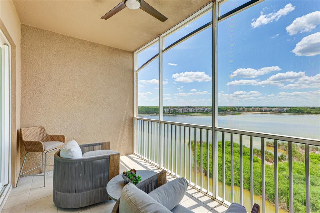 10520 Boardwalk Loop, Unit 704 Lakewood Ranch, FL 34202 - Photo 30 of 55 a living room with furniture and a floor to ceiling window