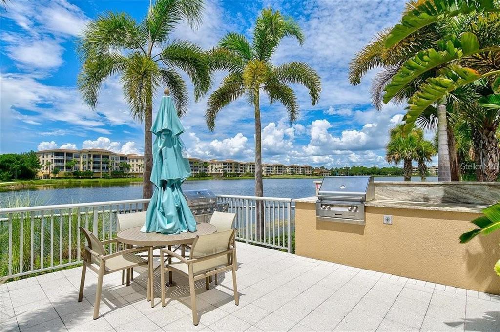 10520 Boardwalk Loop, Unit 704 Lakewood Ranch, FL 34202 - Photo 54 of 55 a view of a lake with a table and chairs