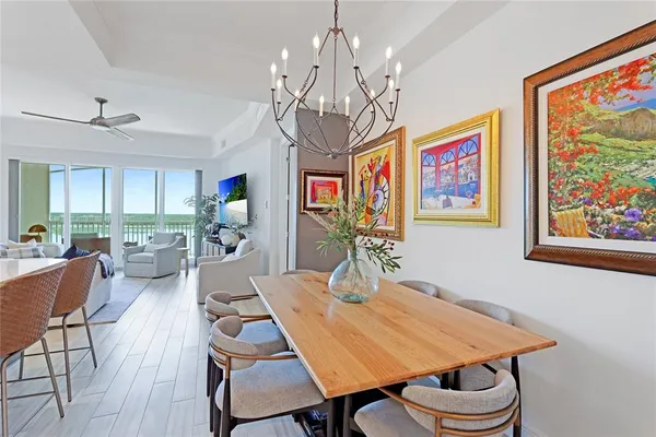 a kitchen with sink cabinets stainless steel appliances and living room view