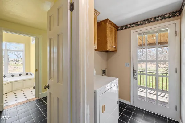 a view of bathroom with bathtub and windows