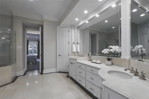 a bathroom with a tub shower and mirror