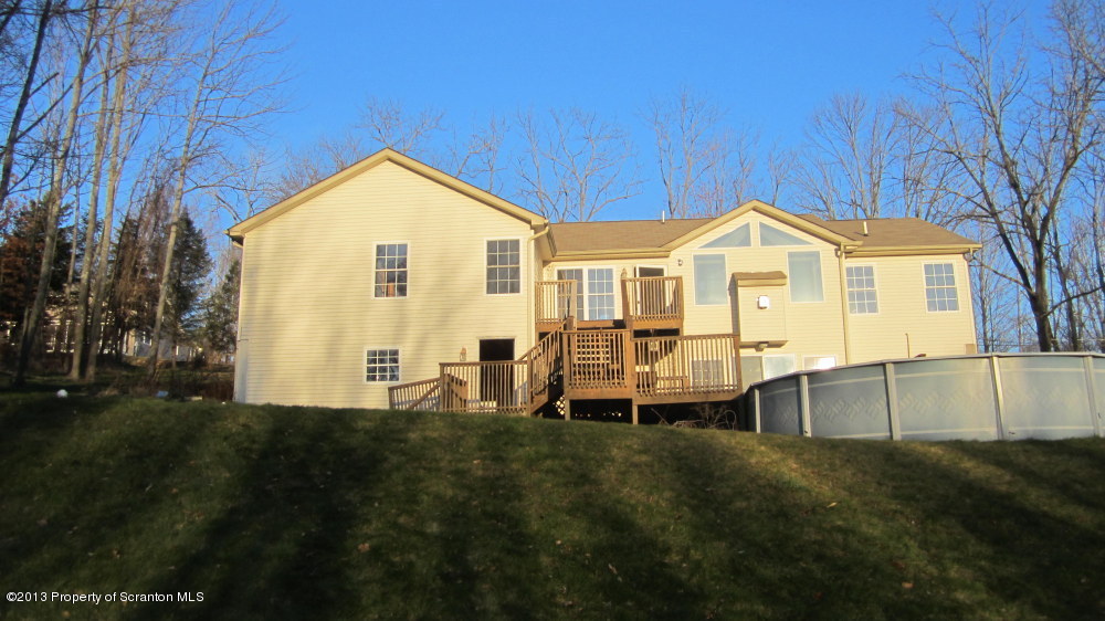 420 Municipal Road Dallas, PA 18612 - Photo 2 of 11 a front view of a house with a yard and trees