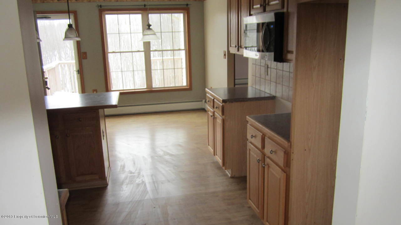 420 Municipal Road Dallas, PA 18612 - Photo 9 of 11 a view of empty room with wooden floor and fan