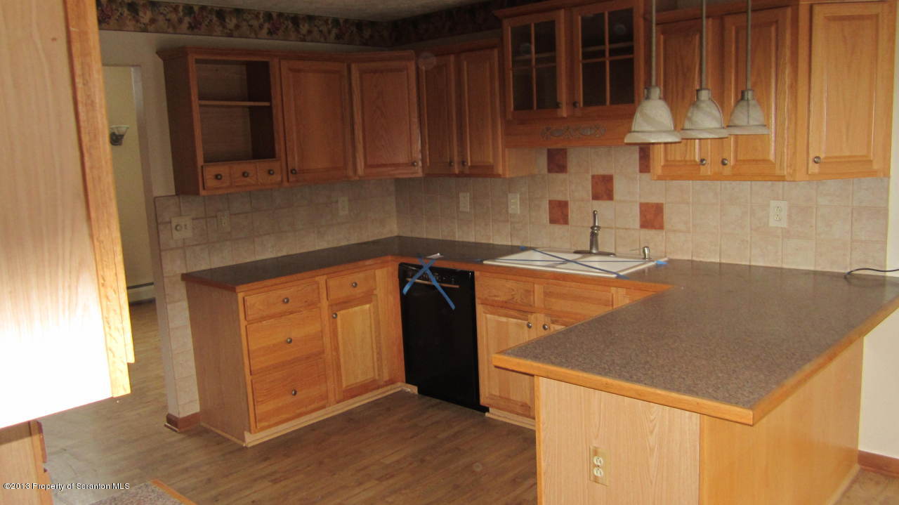 420 Municipal Road Dallas, PA 18612 - Photo 10 of 11 a kitchen with stainless steel appliances granite countertop a sink and a stove