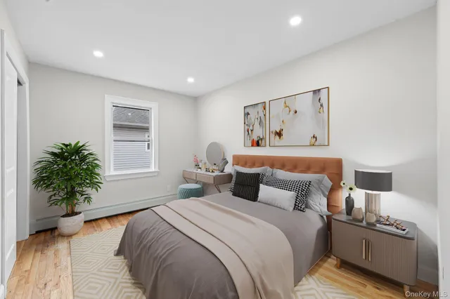 a bedroom with bed and a potted plant