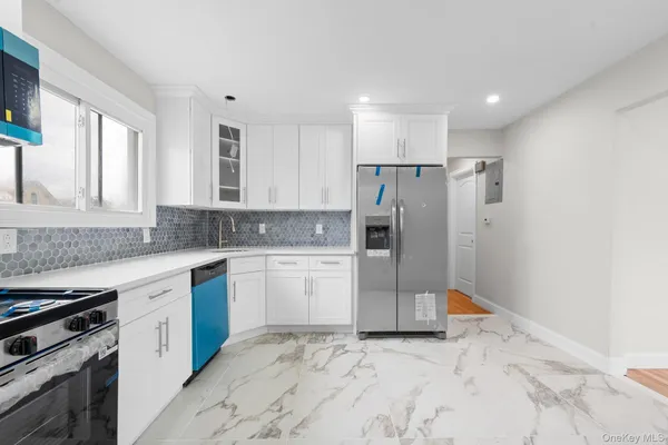 a kitchen with a refrigerator sink and cabinets