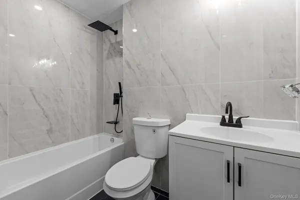 a bathroom with a sink a toilet and a bathtub