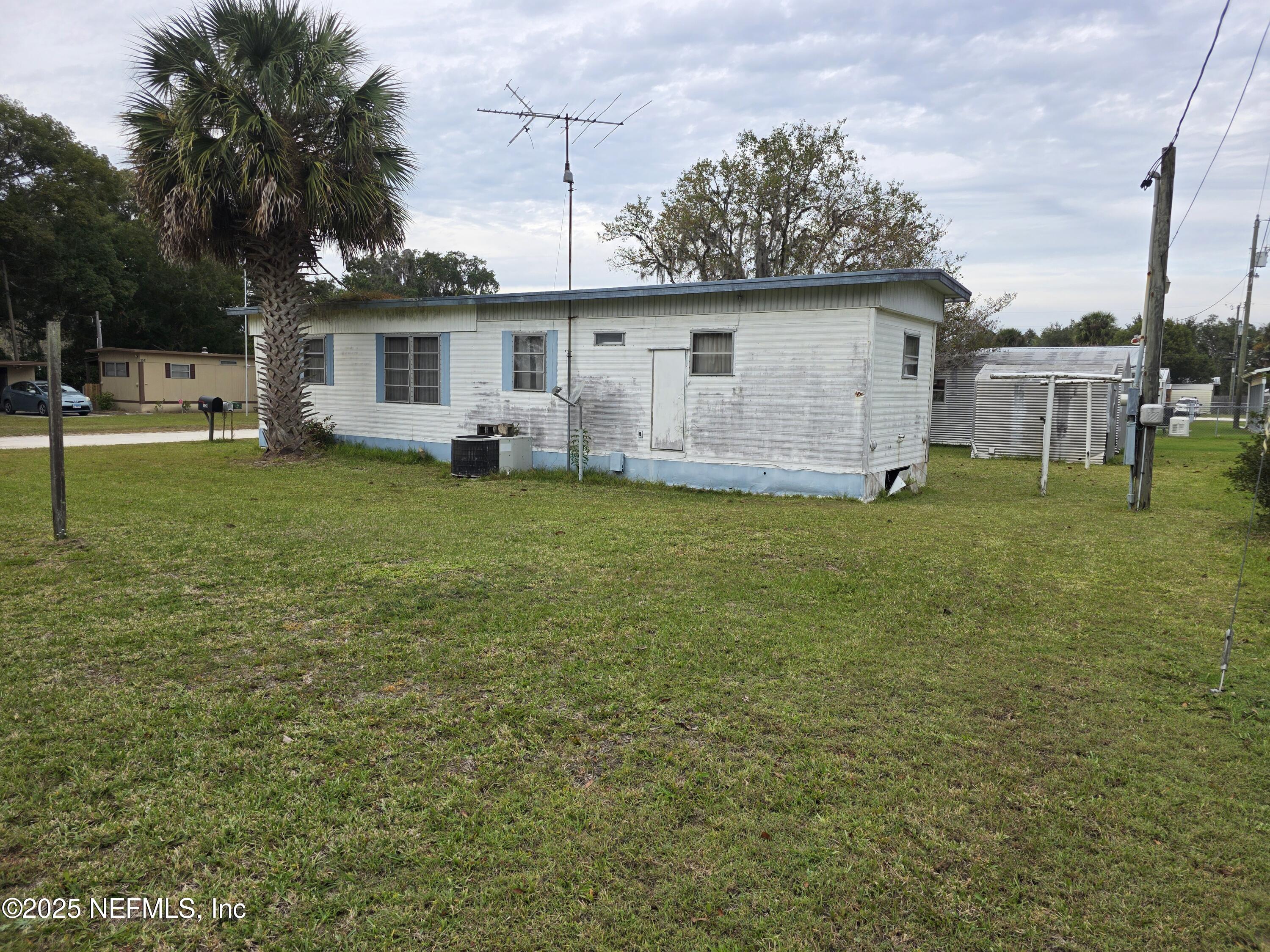 104 Lemon Street Crescent City, FL 32112 - Photo 6 of 8 a view of a house with a backyard
