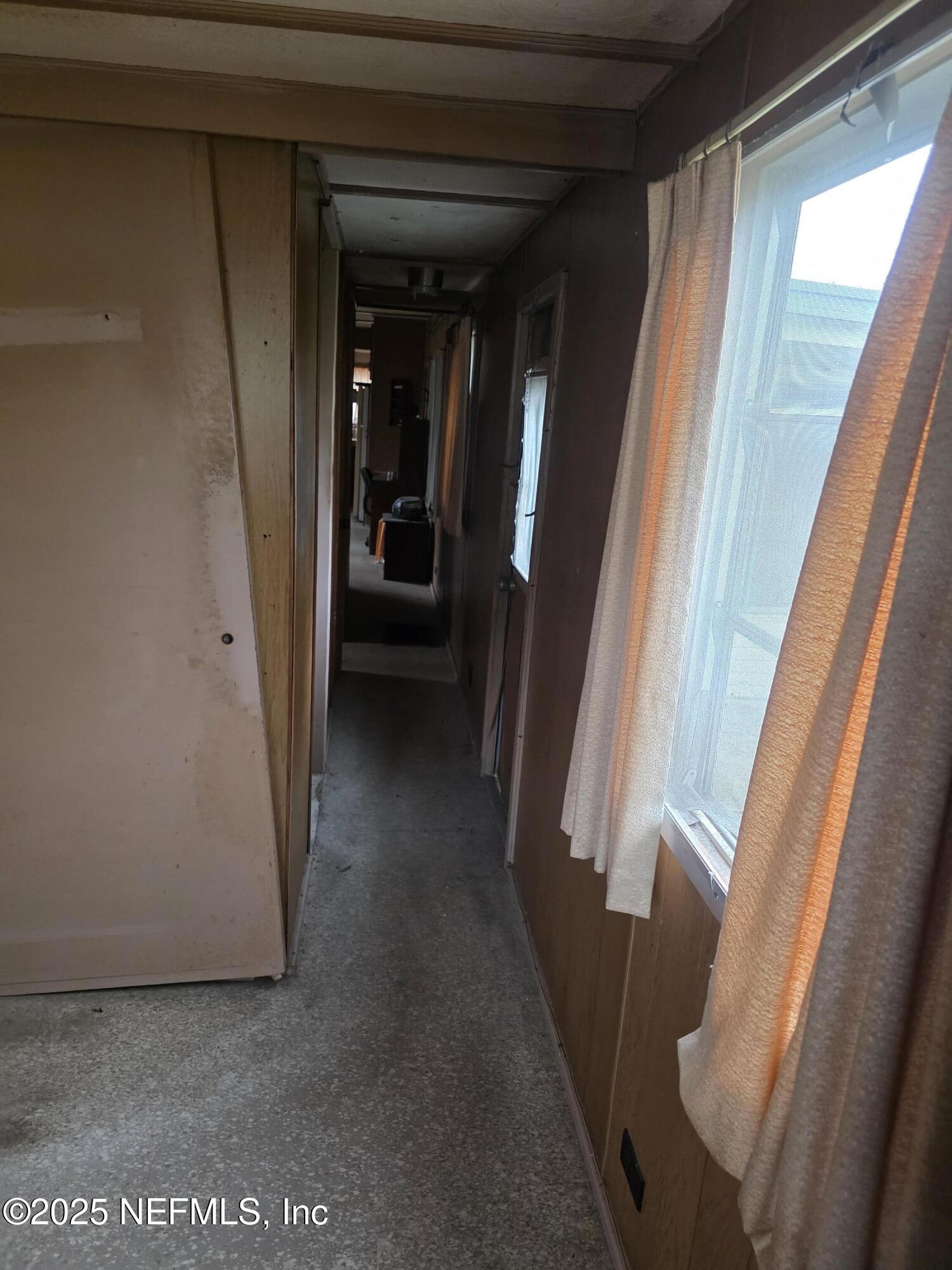 104 Lemon Street Crescent City, FL 32112 - Photo 8 of 8 a view of a hallway with furniture and front door