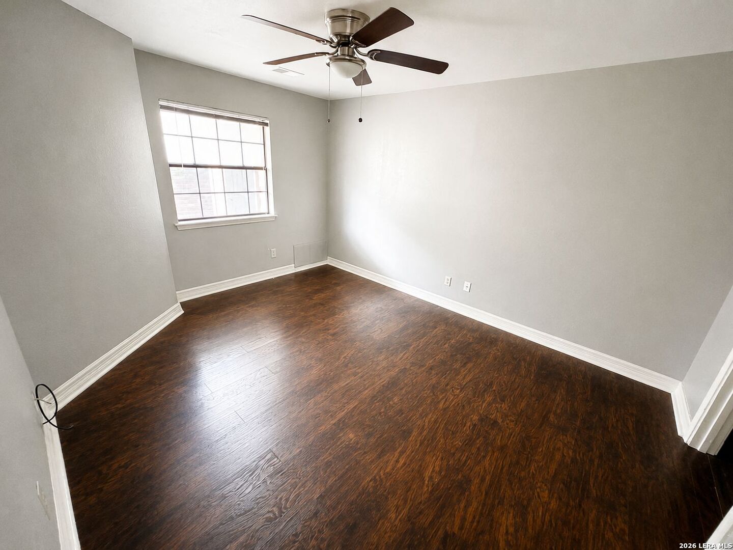 11610 Vance Jackson Road, Unit 867 San Antonio, TX 78230 - Photo 8 of 10 wooden floor in an empty room with a window
