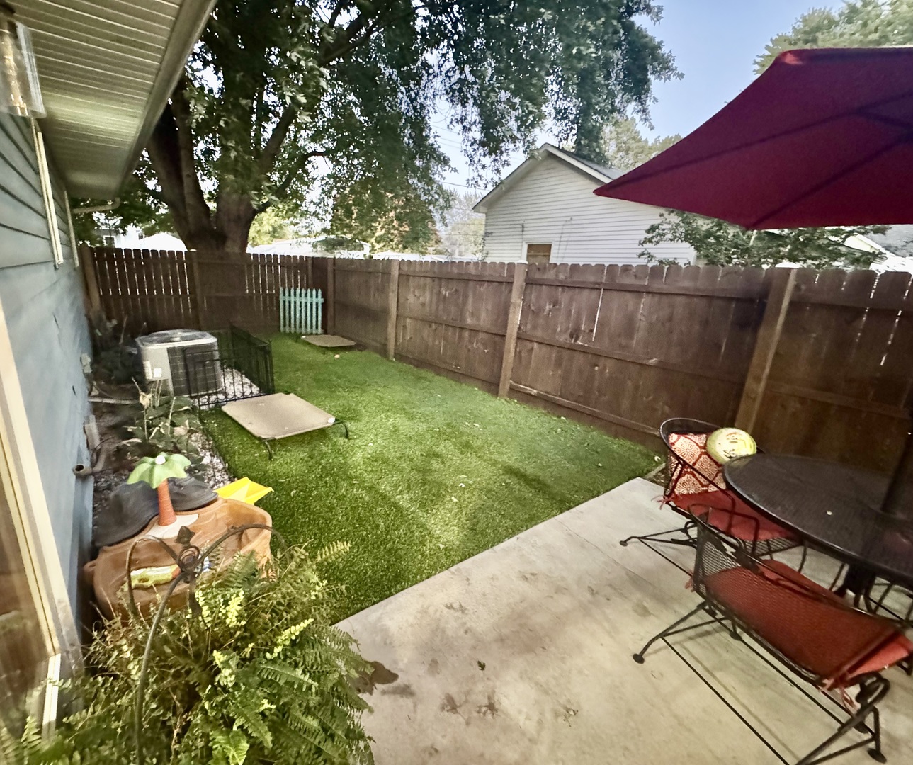 308 North Alexander Street Clinton, IL 61727 - Photo 18 of 20 a view of a backyard with wooden fence