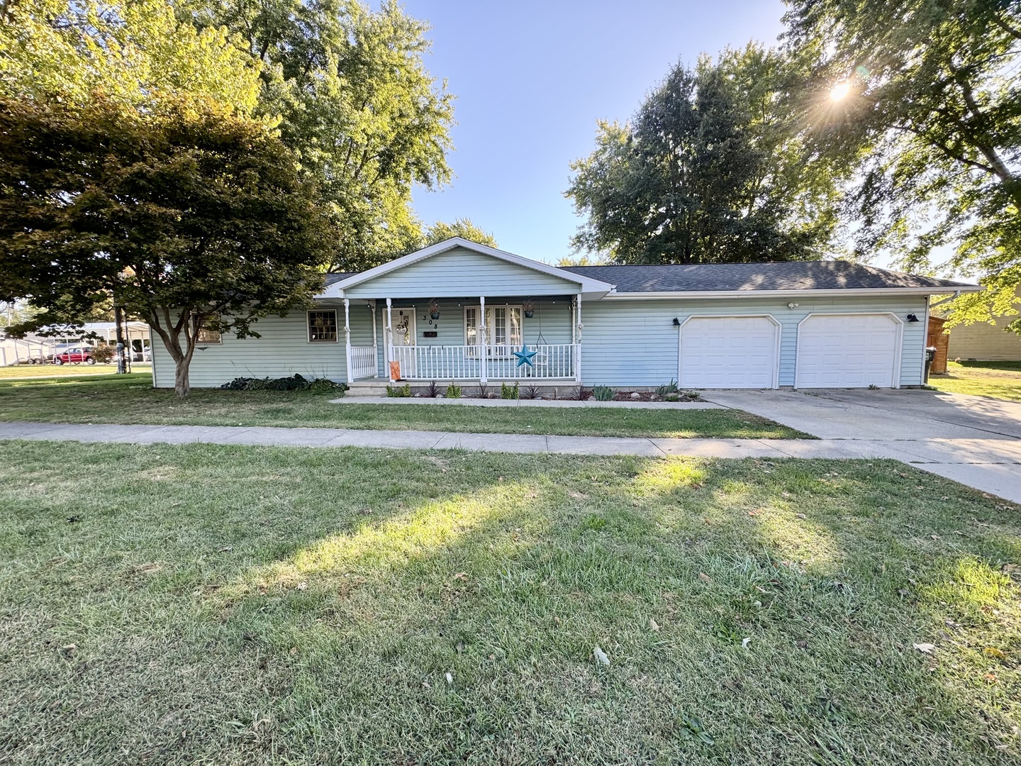 308 North Alexander Street Clinton, IL 61727 - Photo 3 of 20 a view of a house with a big yard and large trees