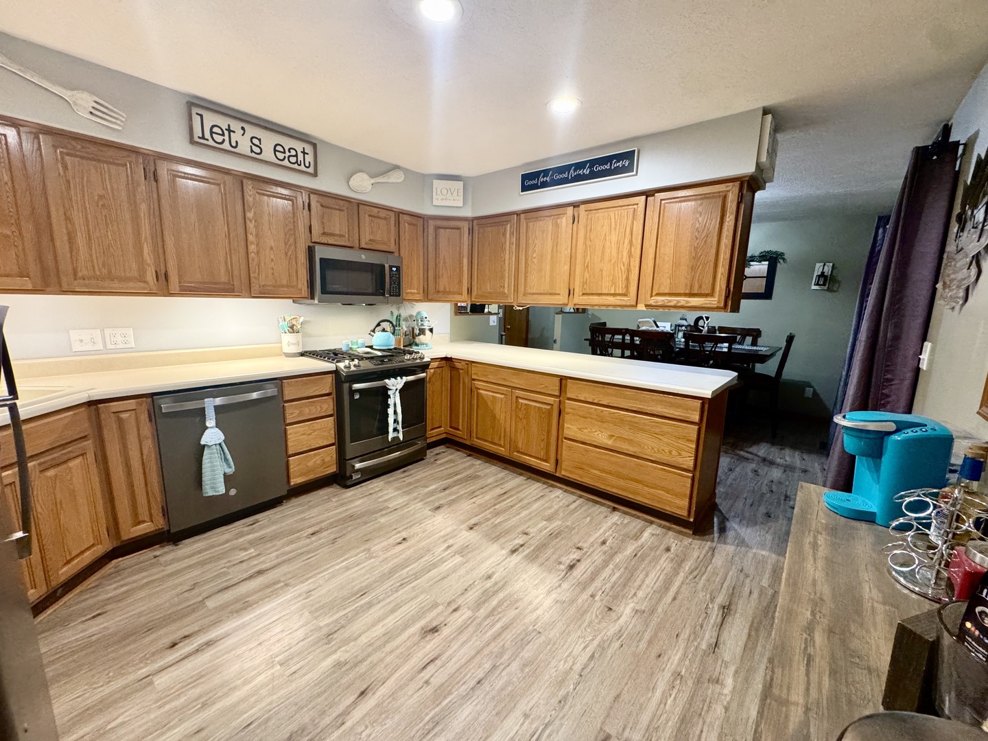 308 North Alexander Street Clinton, IL 61727 - Photo 8 of 20 a kitchen with wooden floors sink and stainless steel appliances