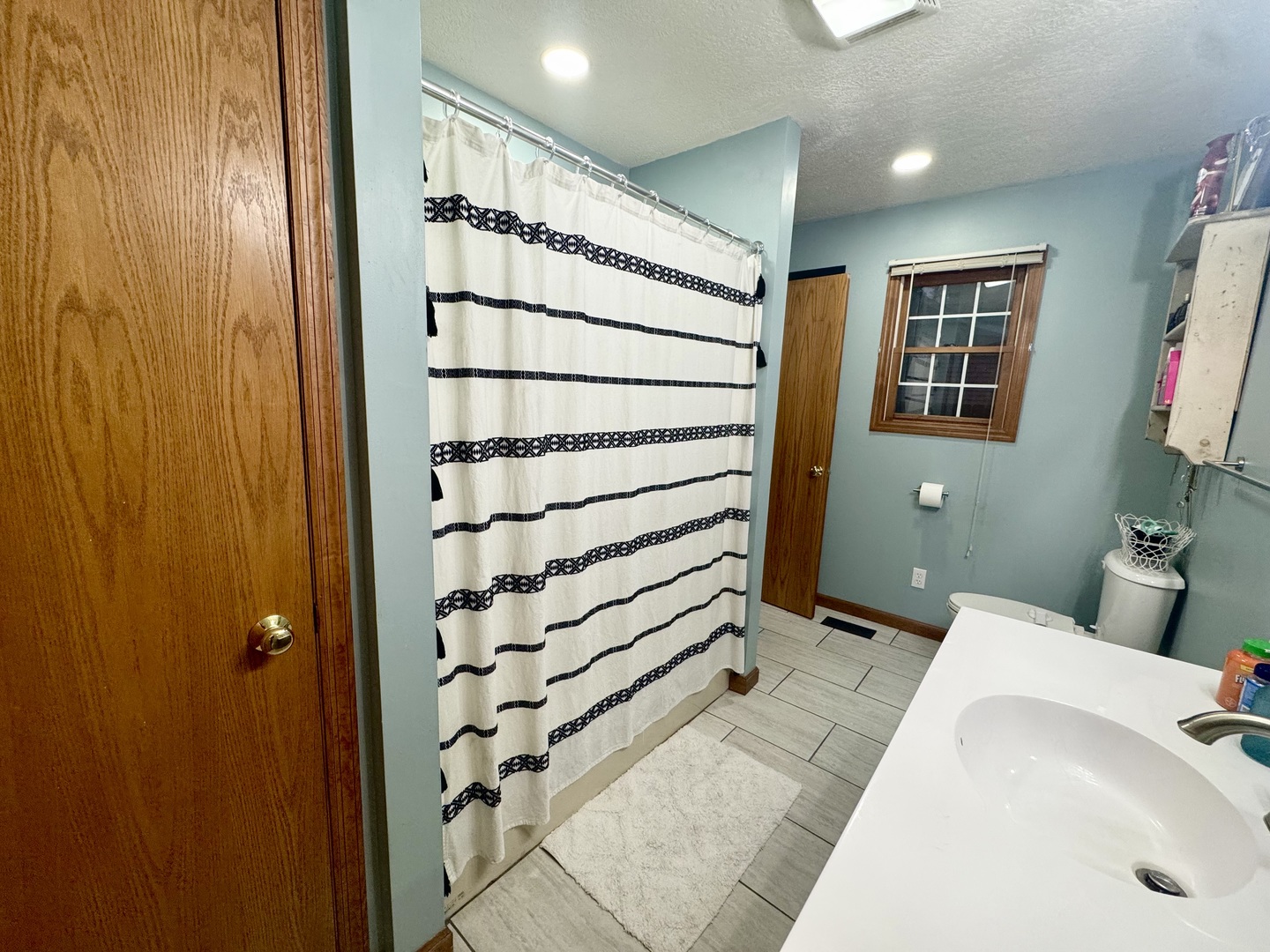 308 North Alexander Street Clinton, IL 61727 - Photo 9 of 20 a bathroom with a sink and a shower
