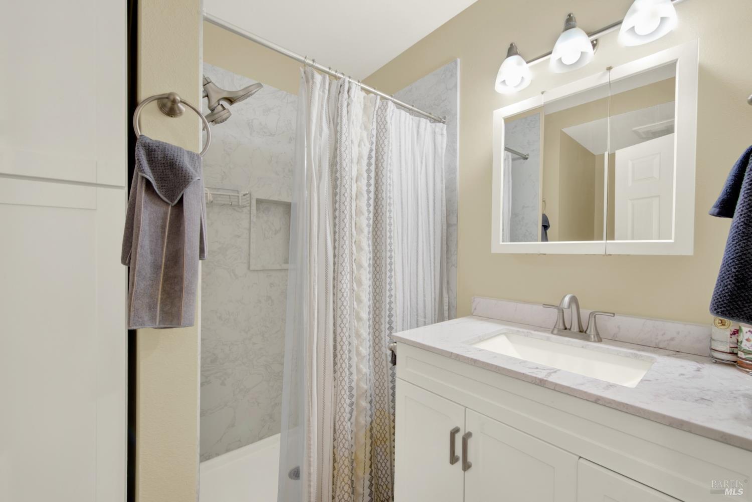 4851 Udell Road Vacaville, CA 95688 - Photo 19 of 65 a bathroom with a granite countertop sink and a mirror