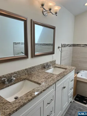 a living room with a bed furniture and wooden floor