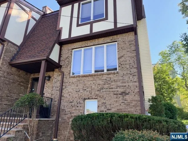 a brick building with plants in front of door
