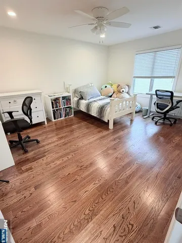 a bedroom with furniture and a wooden floor