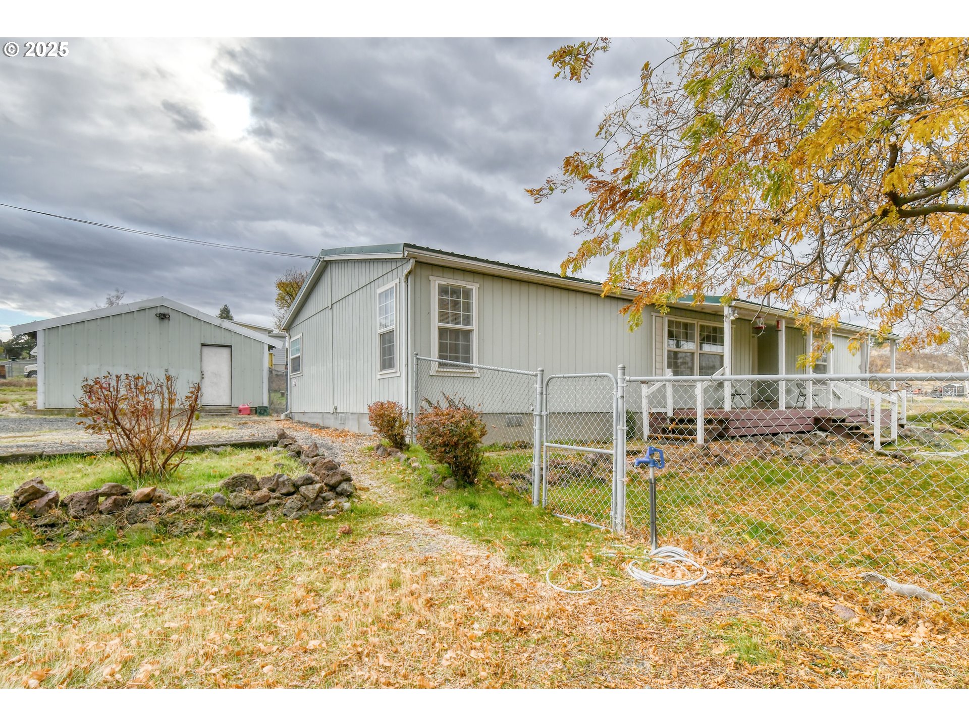 73306 Southeast 54th Street Pendleton, OR 97801 - Photo 2 of 39 a backyard of a house with table and chairs