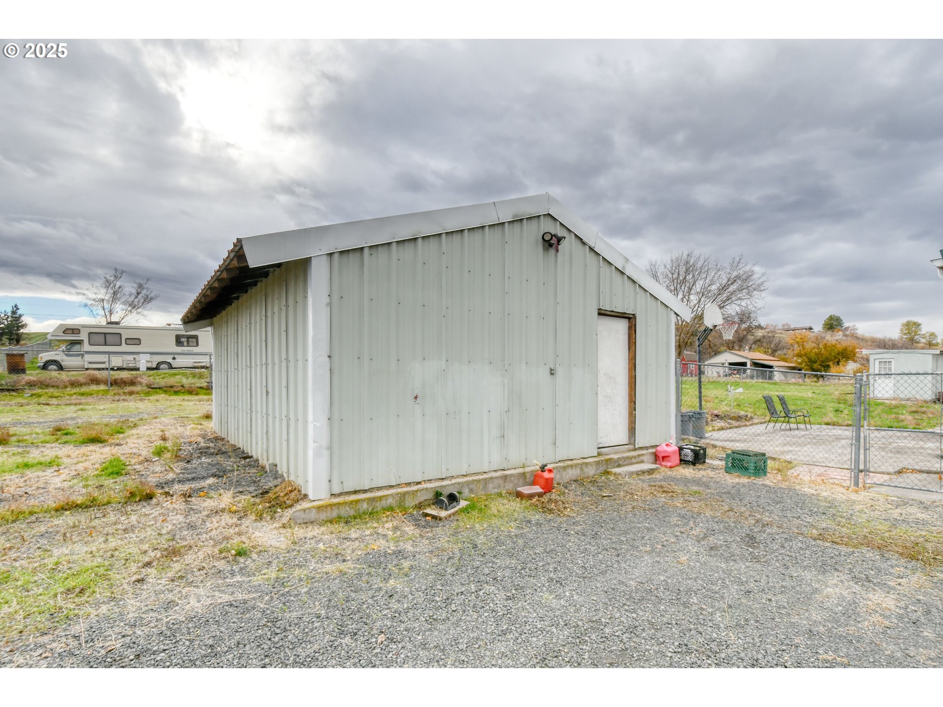 73306 Southeast 54th Street Pendleton, OR 97801 - Photo 27 of 39 a backyard of a house with wooden fence