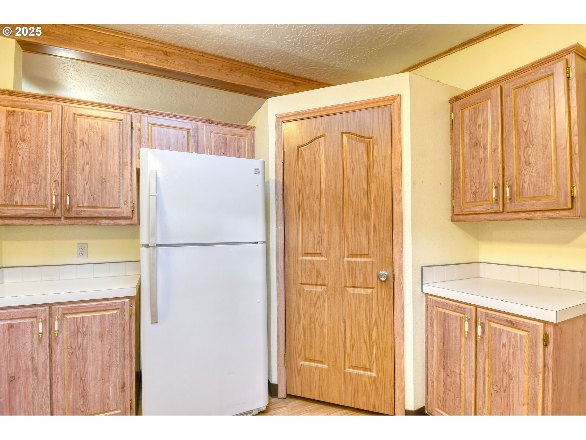 73306 Southeast 54th Street Pendleton, OR 97801 - Photo 9 of 39 a white refrigerator freezer sitting in a kitchen