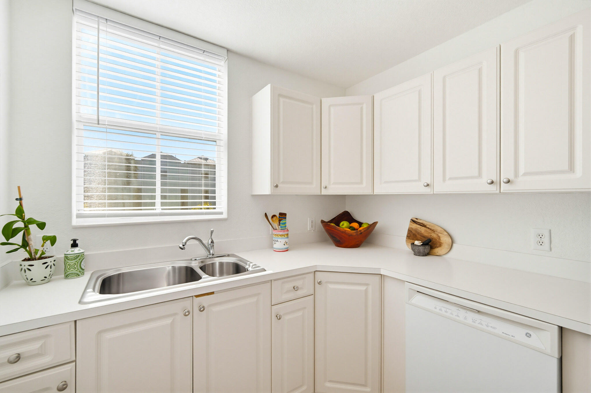 63 Seaside N Court Key West, FL 33040 - Photo 23 of 40 a kitchen with stainless steel appliances white cabinets a sink a window and white cabinets