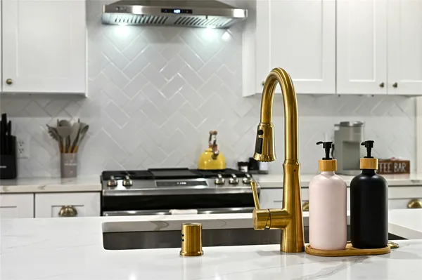 a kitchen with stainless steel appliances kitchen island granite countertop a stove a sink and white cabinets