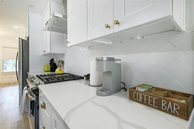 a kitchen with a stove and a refrigerator