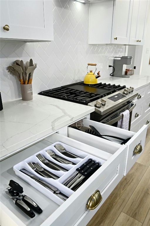 9414 Meadow Vale Austin, TX 78758 - Photo 16 of 37 a kitchen with a stove and a white cabinets
